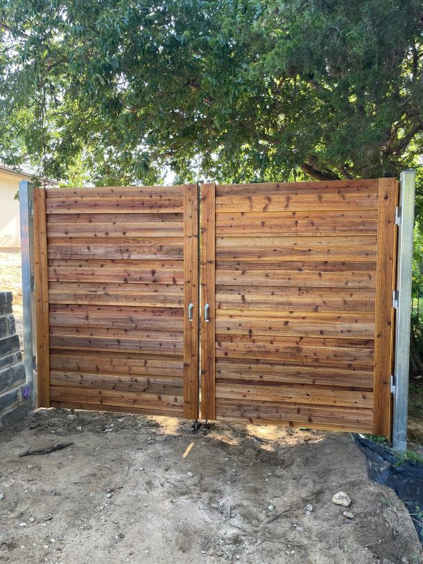 8ft tall double swinging gate with an all iron frame and matching wood to complement the existing fence 1