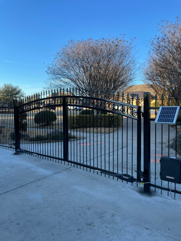 Fully custom decorative iron motorized swinging gate with a single walk through gate and matching fence 1